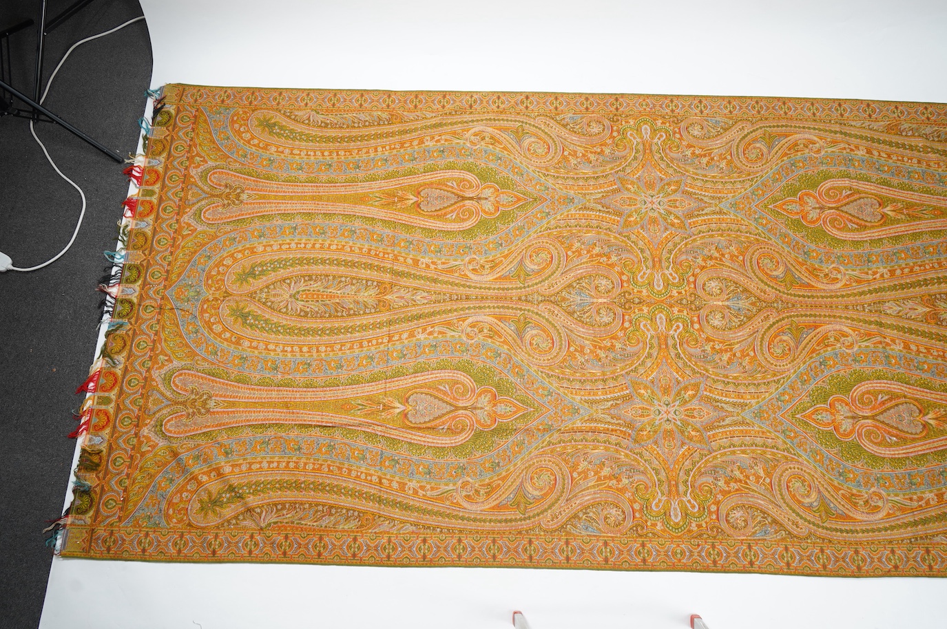 A French possibly Lyon, 19th century ornate silk and fine wool woven Paisley patterned shawl. Woven in polychromes coloured silks and wools on a jacquard loom, using an array of punch cards to create this elaborate desig